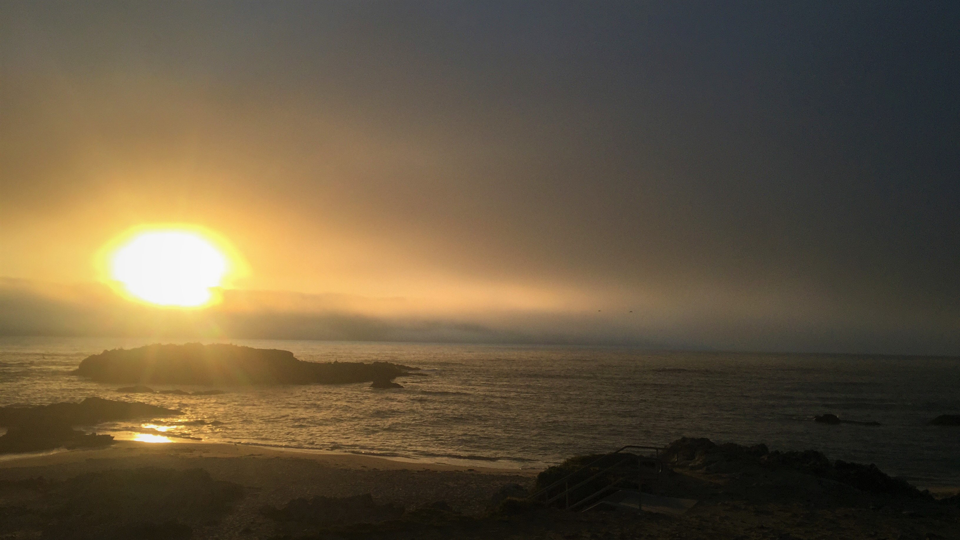 Sunset over Pescadero Beach, California as the fog rolls in. By R.A.Myers.